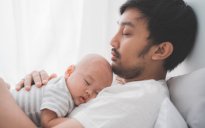 Father holding infant child, representing a family situation where a Texas SAPCR may be used