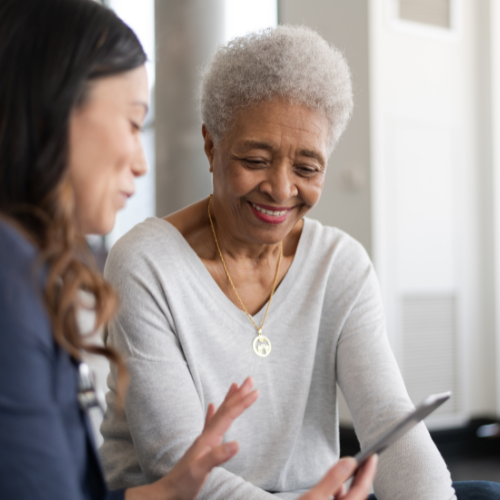Adult daughter helping an older parent review planning information together